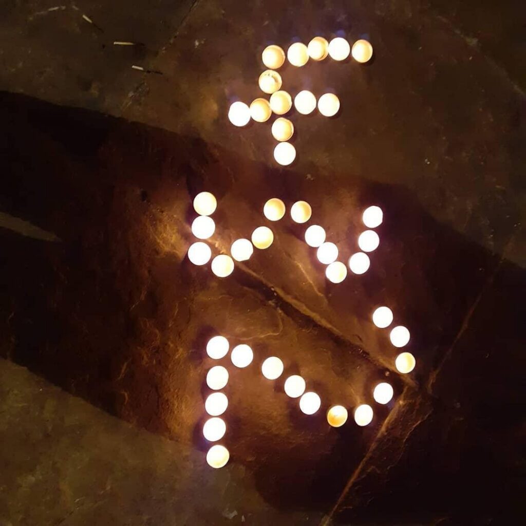 the number 432 made out of candles on a stone floor